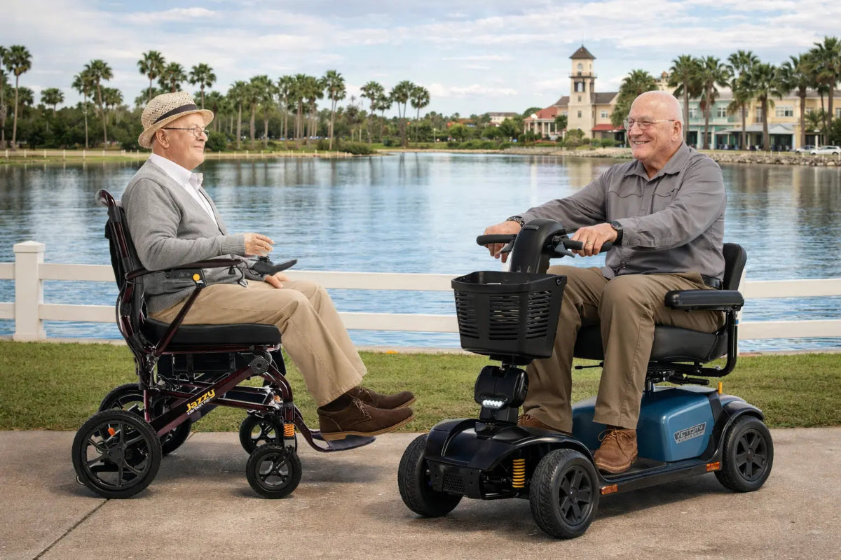 Two men using mobility scooters by a lake with palm trees in the background